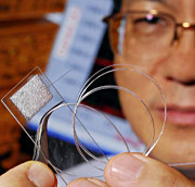 Georgia Tech's Zhong Lin Wang holds a 3-D PV cell 