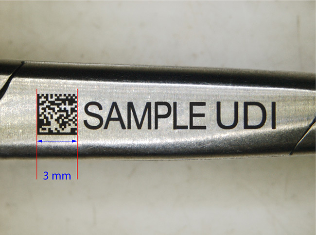 Medical UDI black marking on a stainless steel hemostatic clamp. Courtesy of SISMA SpA.