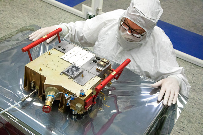 Southwest Research Institute’s Norm Pelletier prepares the Ultraviolet Spectrograph (UVS) for delivery and integration onto the European Space Agency’s JUICE spacecraft. As part of a 10-instrument payload to study Jupiter and its large moons, UVS will measure ultraviolet spectra that scientists will use to study the composition and structure of the atmospheres of these bodies and how they interact with Jupiter’s massive magnetosphere. Courtesy of Southwest Research Institute.