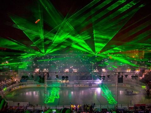 Stock image of laser show in a hockey arena.