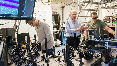 Professor David Awschalom (center) works in his lab at the University of Chicago with graduate students Kevin Miao (left) and Alexandre Bourassa. Courtesy of Jean Lachat.