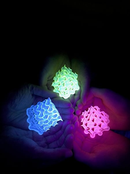 This image shows glowing 3D-printed gyroids made with bright SMILES materials. Courtesy of Amar Flood.