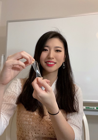 Kyungjin Kim, now a professor at the University of Connecticut, demonstrating a stretched elastomer film. Courtesy of Kyungjin Kim.