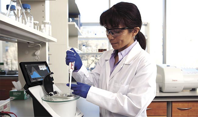 A lab technician uses Thermo Fisher Scientific’s NanoDrop One Microvolume UV-Vis Spectrophotometer, which requires no more than 2 µl of sample. Microvolume spectrometers have emerged as important tools in the testing process for the COVID-19 virus. Courtesy of Thermo Fisher Scientific.