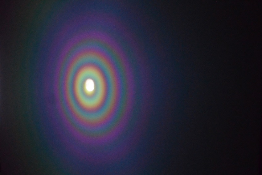 Concentric rainbows are produced when white light is reflected by microscale concave interfaces. Courtesy of Jacob Rada, University of Buffalo.