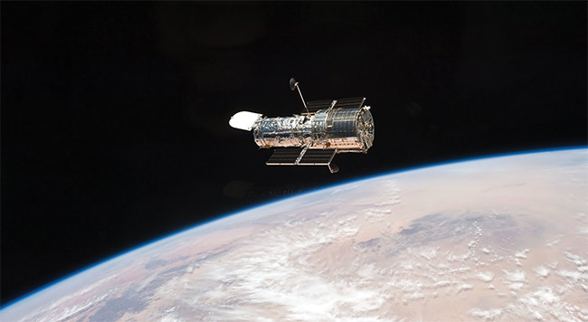 Often traveling at kilometers per second, space debris can cause significant damage to valuable space assets, such as the Hubble Space Telescope, which showed evidence of hundreds of impacts after only two years in orbit. Courtesy of NASA.