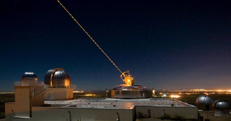 AFRL’s 3.5 meter telescope on Kirtland AFB, N.M. uses its laser to produce a guide star for a reference for adaptive optics, and previously held the record for the smallest telescope to image an asteroid’s satellite. The larger of the two domes to its left houses the 1.5 meter telescope, which now holds the record, without using a laser. Courtesy of Robert Fugate, U.S. Air Force.