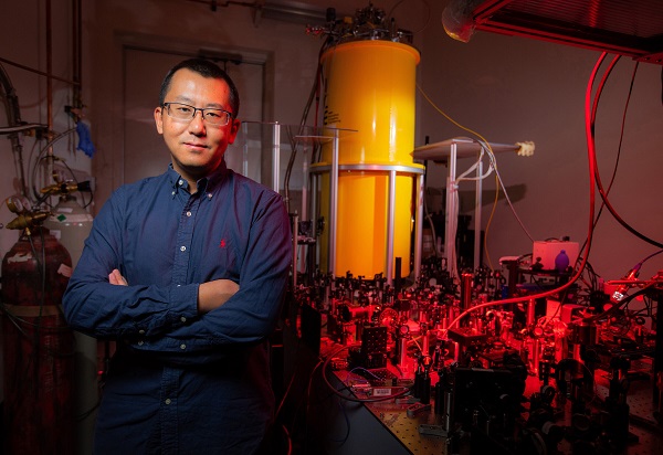 Jigang Wang, a professor at Iowa State University and an Ames National Laboratory senior scientist, with the Cryogenic Magneto-Terahertz Scanning Near-field Optical Microscope. The instrument works at extreme scales of space, time and energy. Its performance is a step toward optimizing the superconducting quantum bits that will be at the heart of quantum computing. Courtesy of Christopher Gannon/Iowa State University.