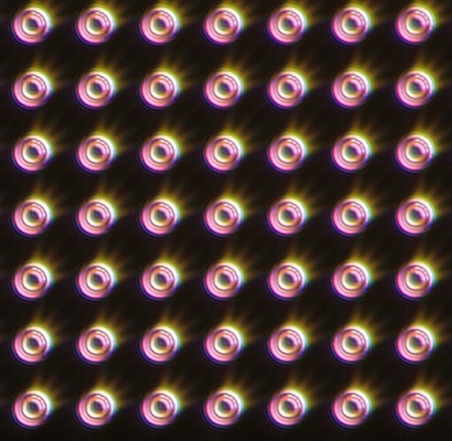 An optical microscope image of an array of integrated photonic devices, used to perform the first all-optical single-spin measurement in silicon. Tens of thousands of such ‘micropuck’ devices were fabricated on a single silicon photonic chip. Courtesy of Simon Fraser University. 