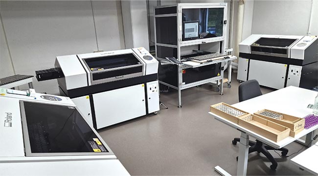 The pvPhotobox (center) along with the inkjet printers that add color to the Hamburg Mint’s coinage. Courtesy of phil-vision.