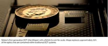 Silotron's first generation OCT chip, Akepa, with a £1 coin for scale. The chip reportedly replaces 70% of the optics contained within a traditional OCT system setup. Silotron reported that it used the chip to that it acquired a sub-surface image of the retina in a synthetic eye. Courtesy of Silotron.