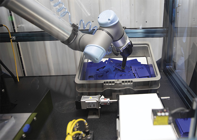 A robot accurately picks up blue plastic parts due to the improvements in vision technology. Courtesy of FPE Automation.