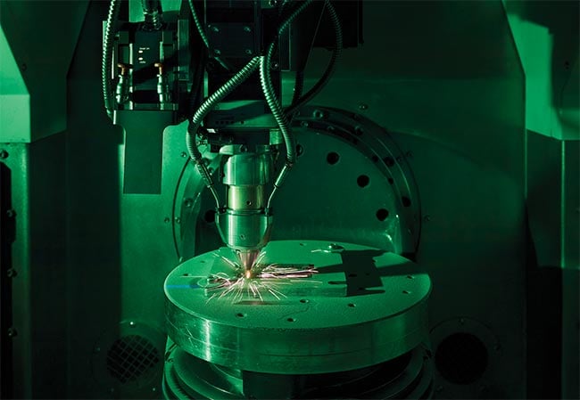 Figure 3. The extreme high-speed laser material deposition (EHLA) method has been transferred into a modified 5-axis computer numerical control system in which the nozzle moves (above). Courtesy of Fraunhofer ILT.