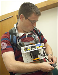 Maurice Fallon, a research scientist in MIT’s Computer Science and Artificial Intelligence Laboratory, demonstrates how a user would wear the sensor. 