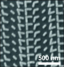 A scanning electron microscopy image of a metasurface comprising V-shaped antennas with a variety of arm configurations.