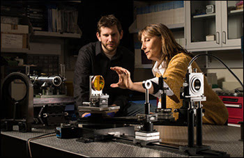Jannick Rolland works with a graduate student on a freeform lens experiment. 