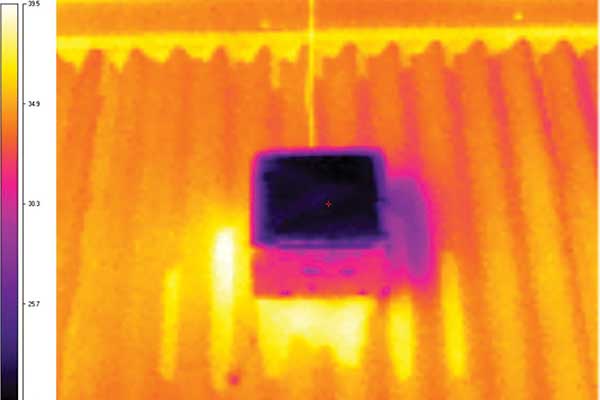 An IR image shows the temperature difference between the new surface (center) and an existing cool roof used in testing.