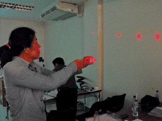 Teachers learn about diffraction with a laser pointer and grating in Chiang Mai, Thailand.