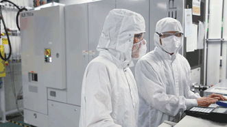 In semiconductor manufacturing, 193-nm wavelength deep-ultraviolet laser sources (white box behind engineers) help fabricate chips with feature sizes approaching 14 nm, which requires a tightly controlled source.