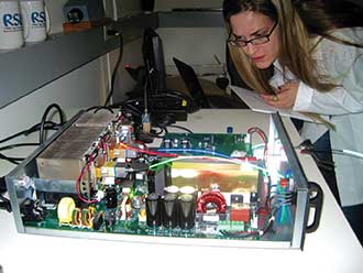 A student intern at RSL Fiber Systems in East Hartford, Conn., works with a laser-based illumination system for fiber optic lighting.