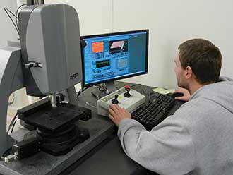 A student intern at Aperture Optical Sciences in Connecticut works with a white light profilometer.