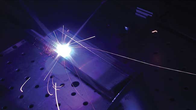 The structured material appears at the left of the laser beam. 