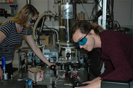 Erica Calman and Chelsey Dorow align optics required to collect measurements from a molybdenum disulfide sample. 