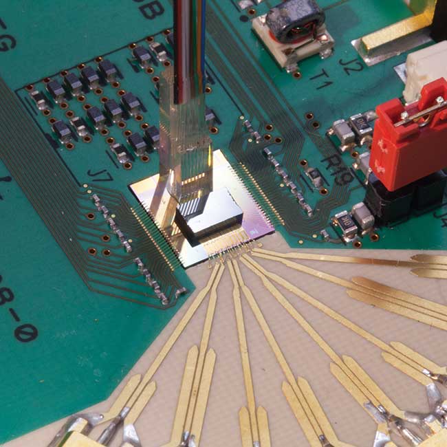 A 100-Gbps receiver with a four-electrical-channel TIA stacked onto a four optical channel photonic integrated circuit. 