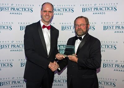 Michael Heckmeier, Head of the Display Materials business unit of Merck KGaA, Darmstadt, Germany, on the left, receives the award for Merck. On the right: Jeff Frigstad, Global Senior Vice President Best Practices at Frost & Sullivan.