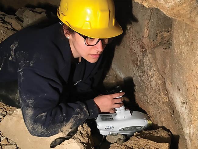A student collects XRF data from the walls of an underground cistern at the Cavità 254 excavation site in Orvieto, Italy. Courtesy of Mary Kate Donais.