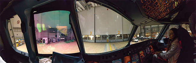 Figure 3. In development at Metamaterial Technologies Inc. (MTI), a new optical metamaterial called metaAIR filters out harmful green laser strikes for vision protection in military and aviation applications (a) (top). MTI founder and CEO George Palikaras holds an aircraft windscreen coated with metaAIR to deflect green laser light (b)(bottom). Courtesy of MTI.