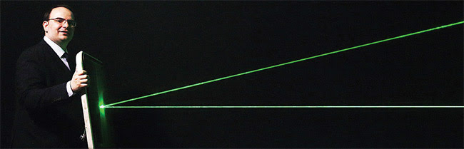 Figure 3. In development at Metamaterial Technologies Inc. (MTI), a new optical metamaterial called metaAIR filters out harmful green laser strikes for vision protection in military and aviation applications (a) (top). MTI founder and CEO George Palikaras holds an aircraft windscreen coated with metaAIR to deflect green laser light (b)(bottom). Courtesy of MTI.