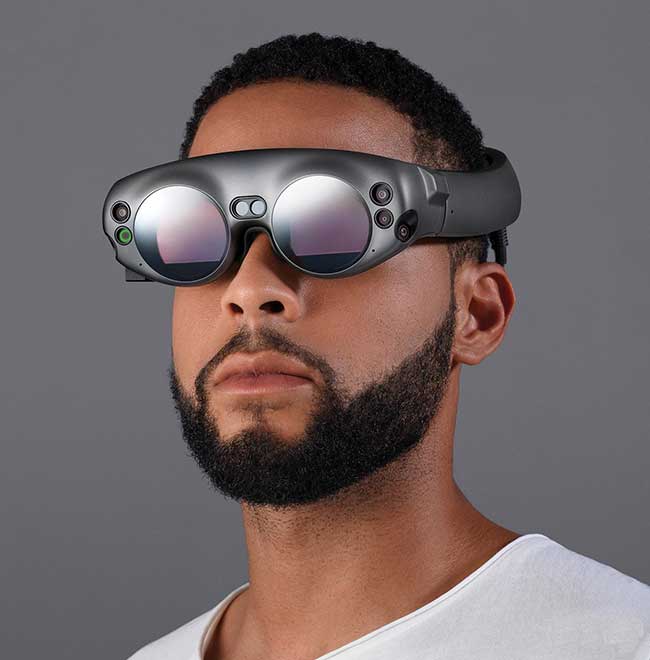 The Magic Leap One AR headset projects holographic virtual images and audio to rounded lenses from an attached computer called Lightpack, about the size of a CD player.