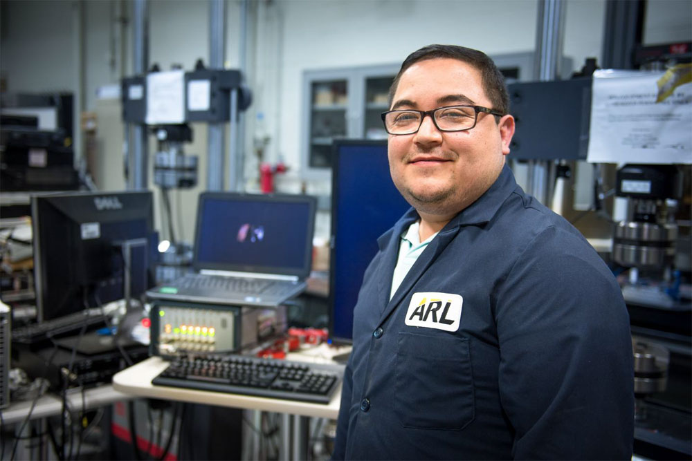 Frank Gardea, a research engineer with the US Army Research Laboratory's Vehicle Technology Directorate, collaborated with the University of Maryland to develop a technique that causes a composite material to become stiffer and stronger on-demand when exposed to UV light. Courtesy of US Army/David McNally.