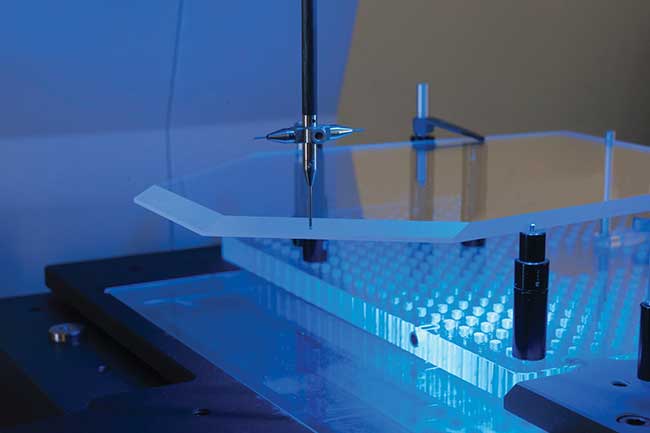 Esco Optics machinery measures an aircraft head-up display panel. 