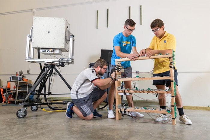 UD students Kyle Weidmann (left), Cooper Hurley (center), and William Beardell worked on this millimeter wave device as part of their capstone senior design project. Courtesy of University of Delaware.