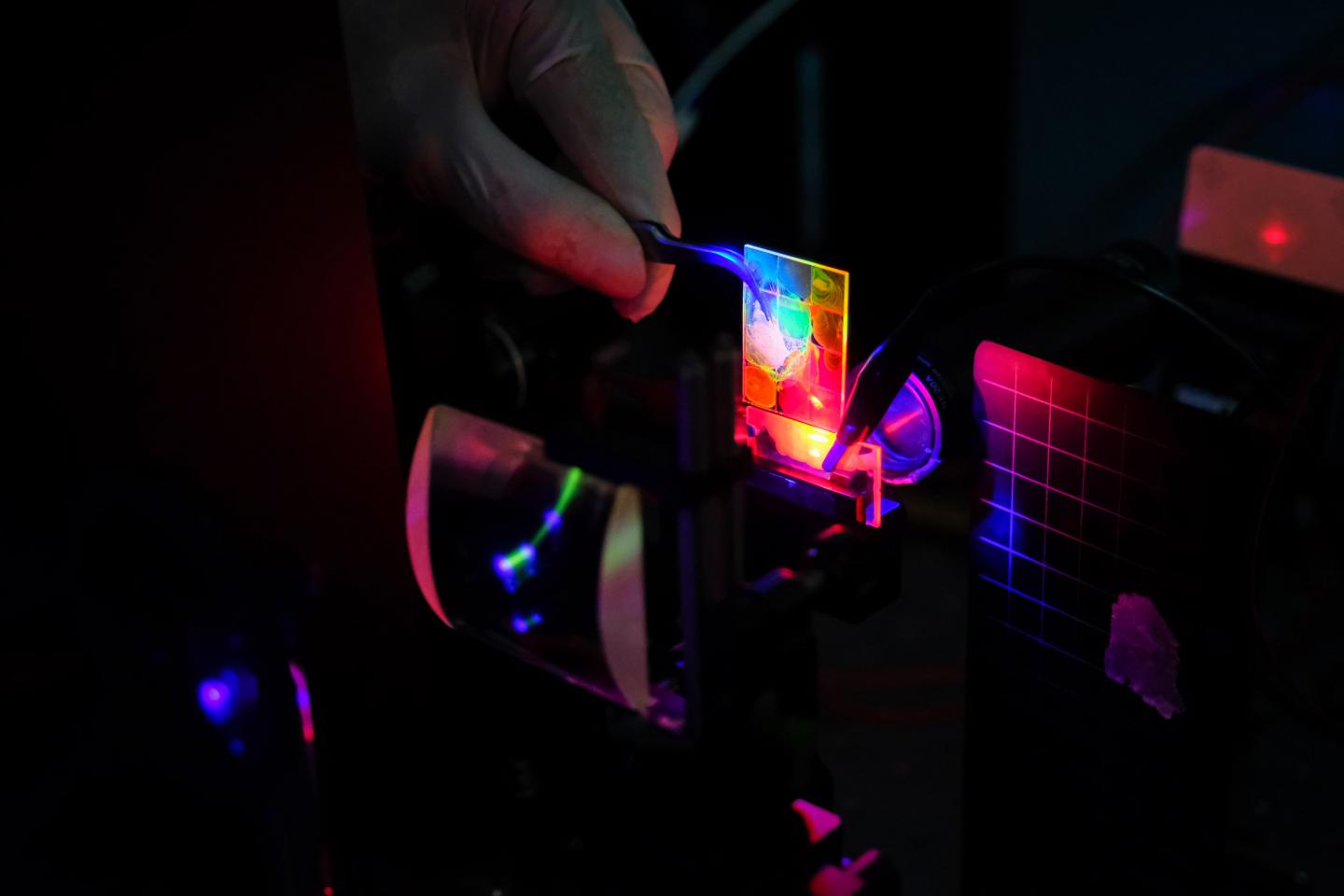 Glass plates with colloidal quantum dots emitting light when electrically and optically pumped. Courtesy of NTU Singapore.
