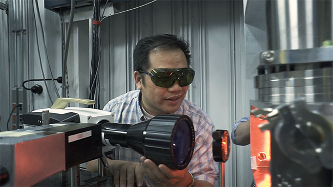 Tao Sun, an x-ray physicist at the U.S. Department of Energy’s Argonne National Laboratory, lines up an IR camera, the first to be installed at an x-ray synchrotron source. The setup provides 3D images of the printing process in nearly real time to benchmark printing processes. Calibrating the x-ray results to the IR camera will allow the use of such cameras to detect defects in processing on manufacturing lines. Courtesy of Argonne National Laboratory.