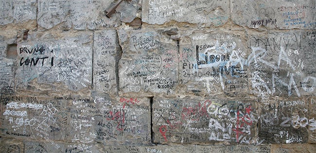 Graffiti stains the walls of the Ponte Vecchio before being removed by a LaserBlaster.