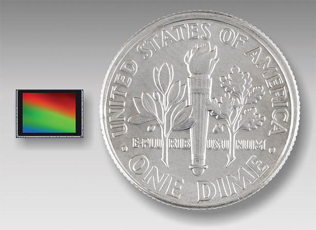 Sensors for surveillance applications, such as this one to the left of the dime, pack megapixels into small areas. They are designed and engineered for illumination levels from full sun to bright moonlight. Courtesy of ON Semiconductor. 