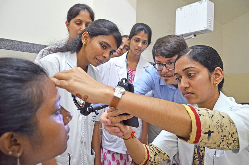 At Sankara Eye Hospital in Bangalore, Dr. Maximilian Wintergerst trains medical assistants in smartphone-based funduscopy. Courtesy of Augenklinik/UK Bonn.