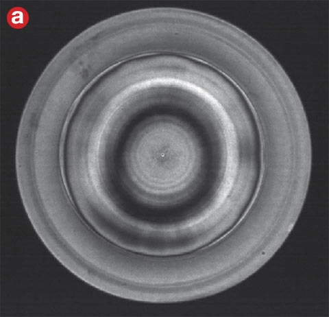 Figure 4. Defocusing removes high-density fringes to create a resolvable image. An interferogram measured directly from an interferometer (a). The resulting map of the surface generated (b). Courtesy of Edmund Optics.