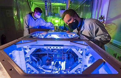 Frederik Tuitje (right) and Tobias Helk from the University of Jena in Germany prepare the setup for an investigation of a laser-plasma source. Courtesy of Jens Meyer/University of Jena.