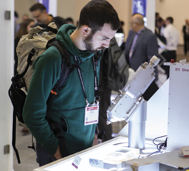An attendee observes new optical technology up close. Images are from the BiOS 2020 in-person event. Courtesy of SPIE.