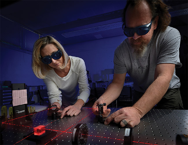 Students construct an experiment to determine the polarization extinction ratio of a polarizing beamsplitter (top). A student characterizing the properties of a polarizing beamsplitter (bottom). Courtesy of Montana State University.