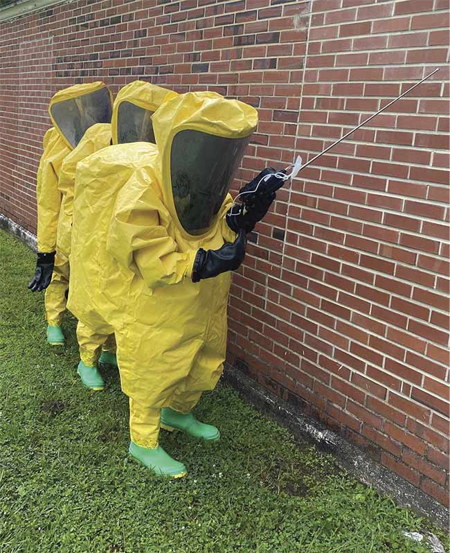 Chemical, biological, radiological, and nuclear defense specialists of the U.S. Marine Corps 2nd Marine Logistics Group and 22nd Marine Expeditionary Unit perform threat assessments using portable spectrometers while wearing bulky PPE. Such applications and user requirements pose important considerations when designing portable spectrometer instruments. Courtesy of Jake Herr.