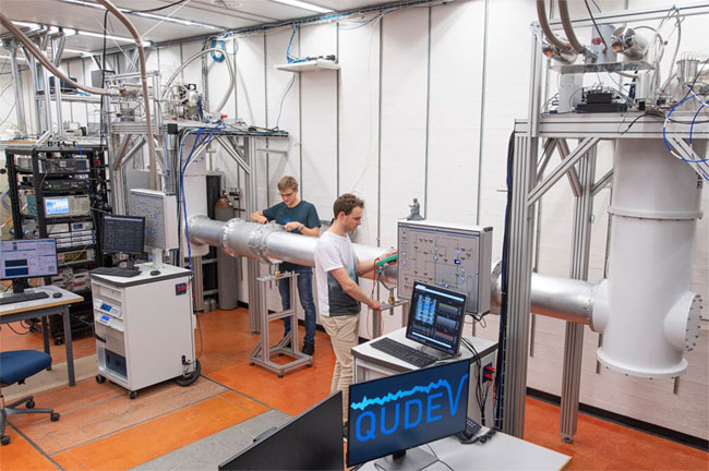 The ETH quantum link in Andreas Wallraff’s laboratory. The tube at the center contains the strongly cooled waveguide that connects the two quantum chips in their cryostats via microwave photons. Courtesy of ETH Zurich Department of Physics/Heidi Hostettler.