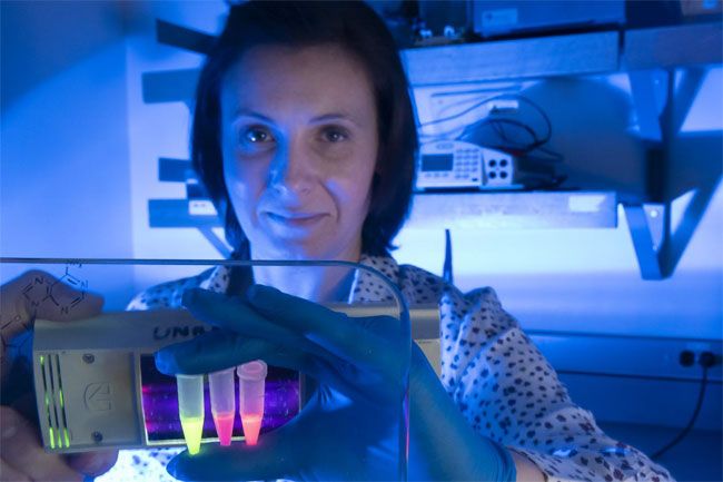 SFU researcher Lena Dolgosheina holds up tubes to demonstrate the Mango imaging technology. Courtesy of Simon Fraser University.