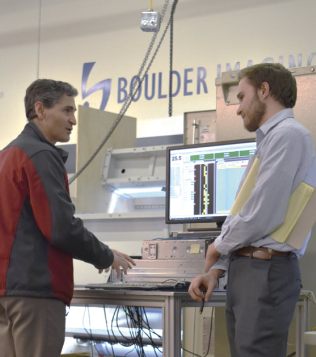 Carlos Jorquera, Boulder Imaging CEO and chief technology officer (left), and Andrew Bour, the company’s field application engineer, on the factory floor testing the system. Courtesy of Boulder Imaging.