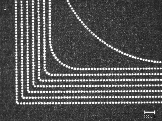 Figure 7. High-precision and equidistant laser pulses, marked with varying speeds. The spot velocity at the corner points is 0, 100, 200, 400, 800, 1500, 3000, and 6000 mm/s (from outside to inside). The process executed without spot distance control (a) and with spot distance control (b). Courtesy of SCANLAB.